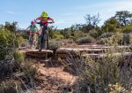 Mountain Bikers Hucking Drop on the Mustang Loop.jpg