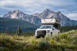 Man Walking at Overlanding Campsite Below Sawtooth Mountains.jpg