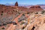 Ford F250 Equipped with Four Wheel Campers Hawk UTE Driving on Dirt Road Below Henry Mountains.jpg