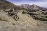 Mountain Biker Descending Slickrock Slab Below Mount Kinesava and West Temple on Holy Guacamol...jpg