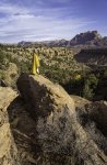 Woman Enjoying Cool Autumn Morning with Voited Blanket Standing on Boulder Below Mount Kinesav...jpg