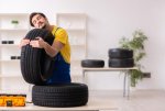 young-garage-worker-tyre-workshop-young-male-garage-worker-tyre-workshop-227449140.jpg