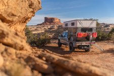Sandstone Rock Framing Overlanding Camper and Monitor Butte Near Moab.jpg