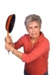 4864121-a-mother-gets-ready-to-swing-her-frying-pan-in-anger.jpg
